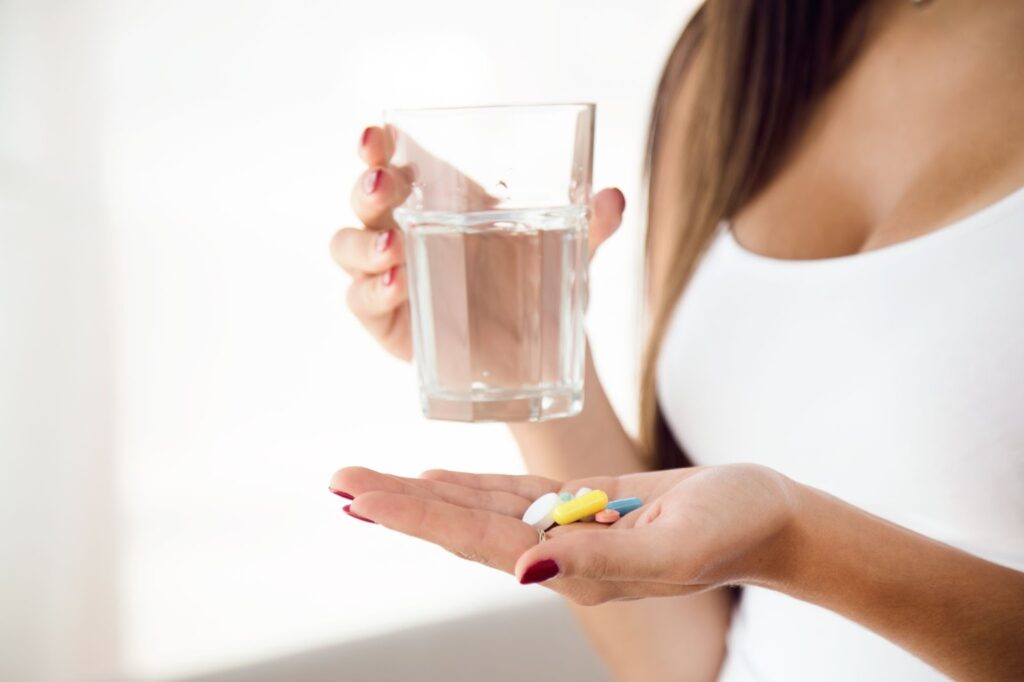 Woman taking pills at home