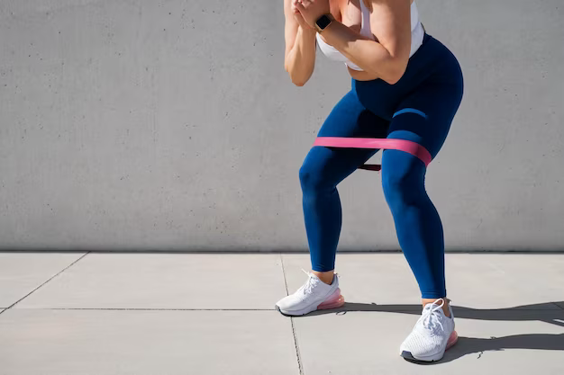 Woman exercising outdoors with elastic band